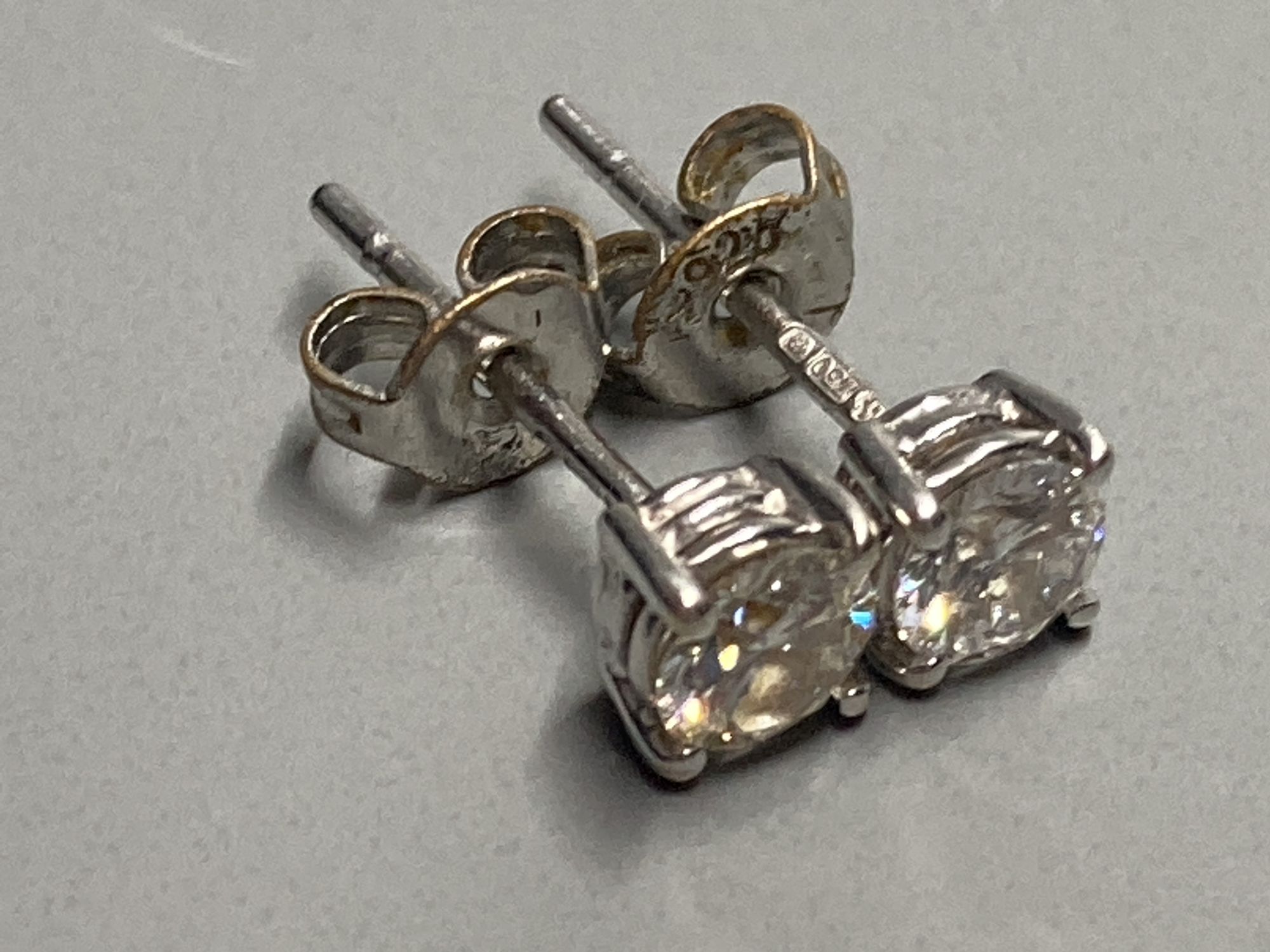 A modern pair of 18ct white gold and solitaire diamond set ear studs, gross 1 gram.